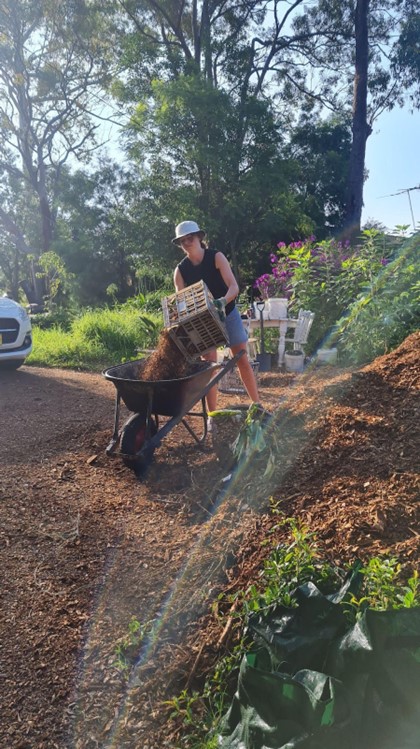 Volunteer Oceane Bertrand spreading bark mulch at the Urban Farmer Blue Mountains