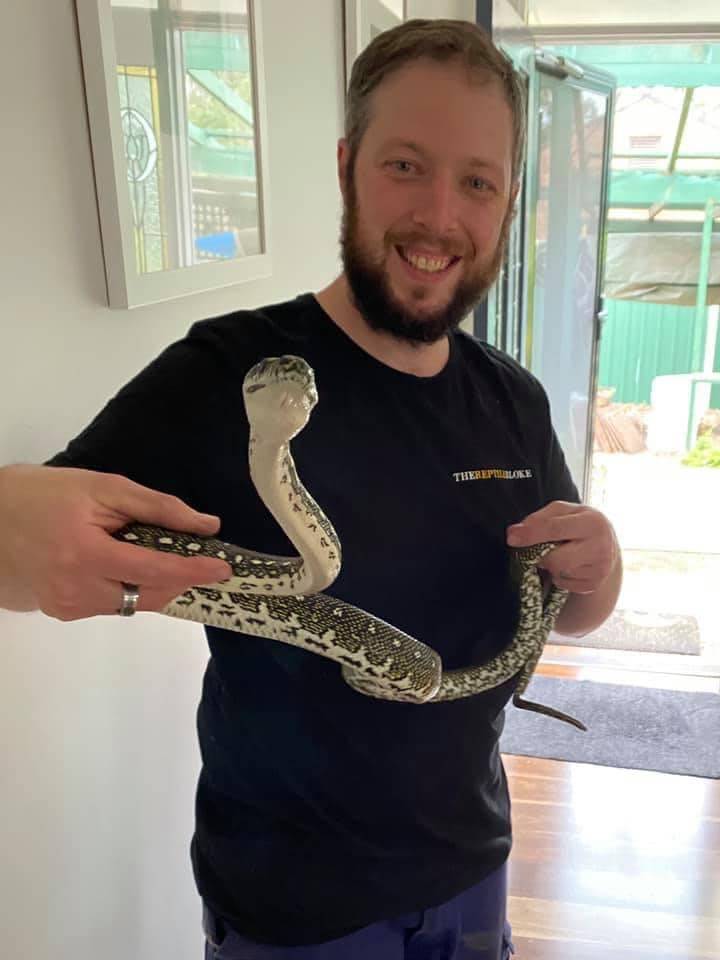 Troy Hovenden the reptile bloke with a snake